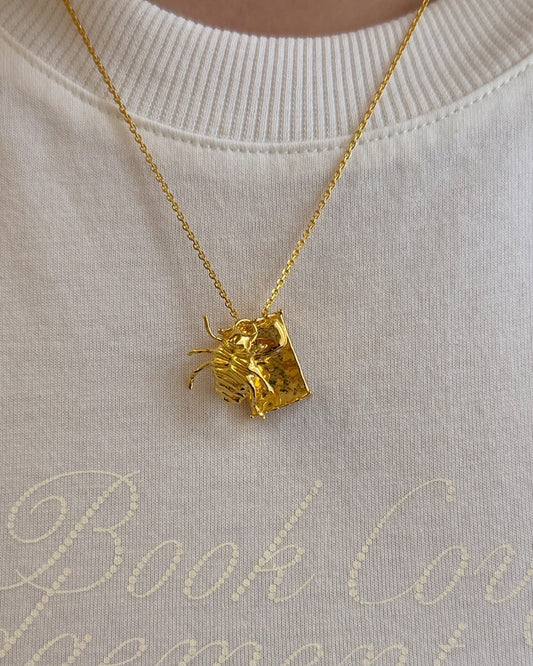 Gregor Samsa Necklace in gold worn with tshirt