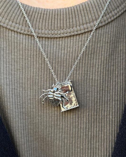 Gregor Samsa Necklace in silver worn with tshirt