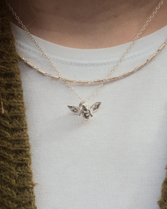 Pen Necklace worn on tshirt with Cupid Necklace