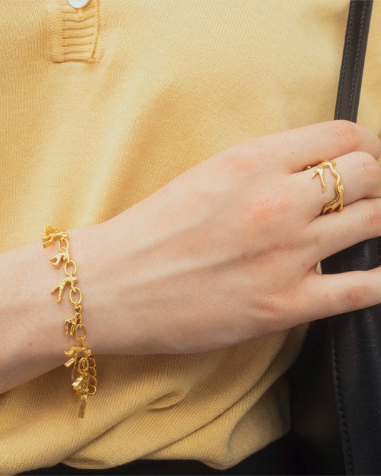 Dance Bracelet in gold worn by female in yellow top