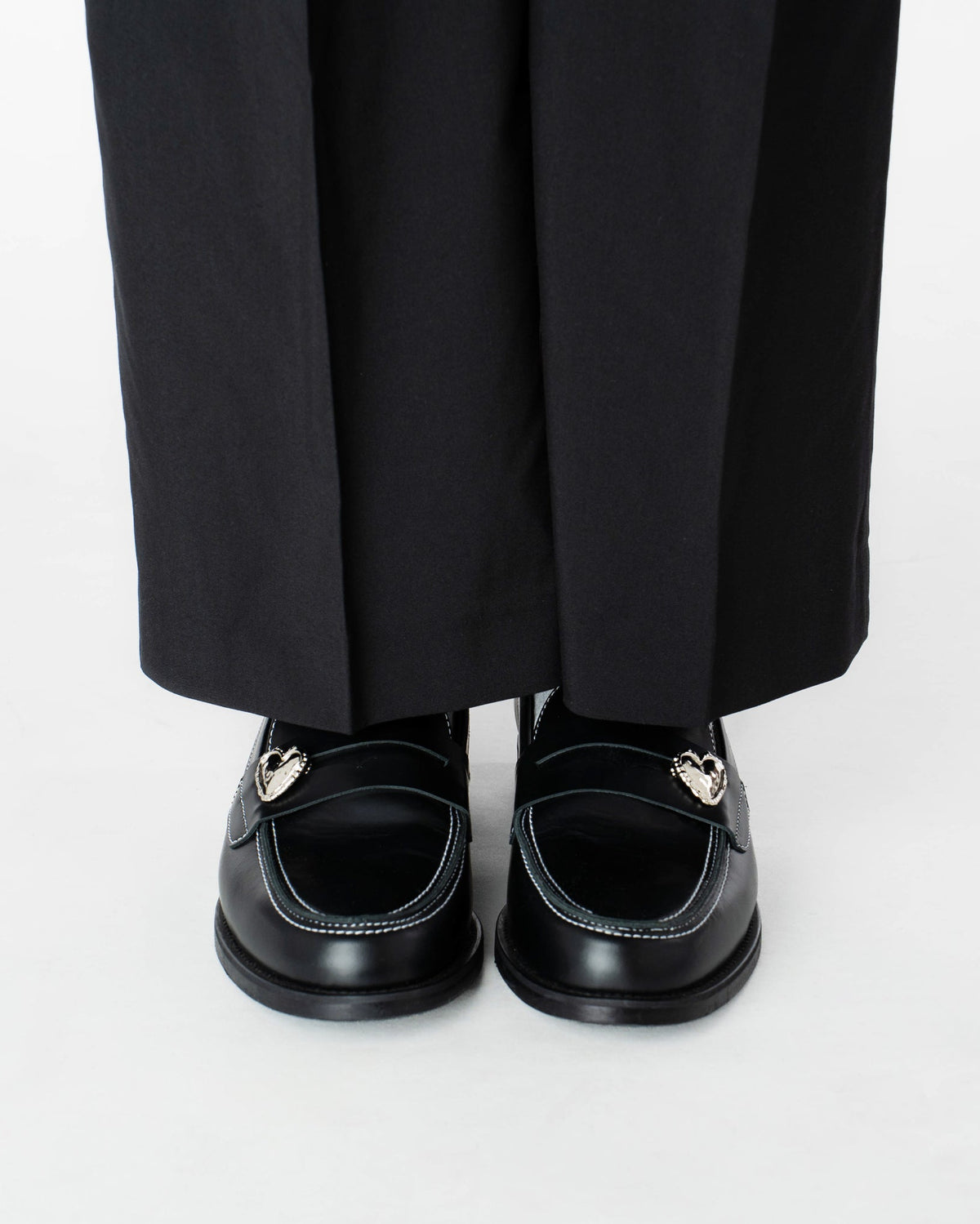 Heart Penny Pins on a pair of penny loafer wearing them in a front view