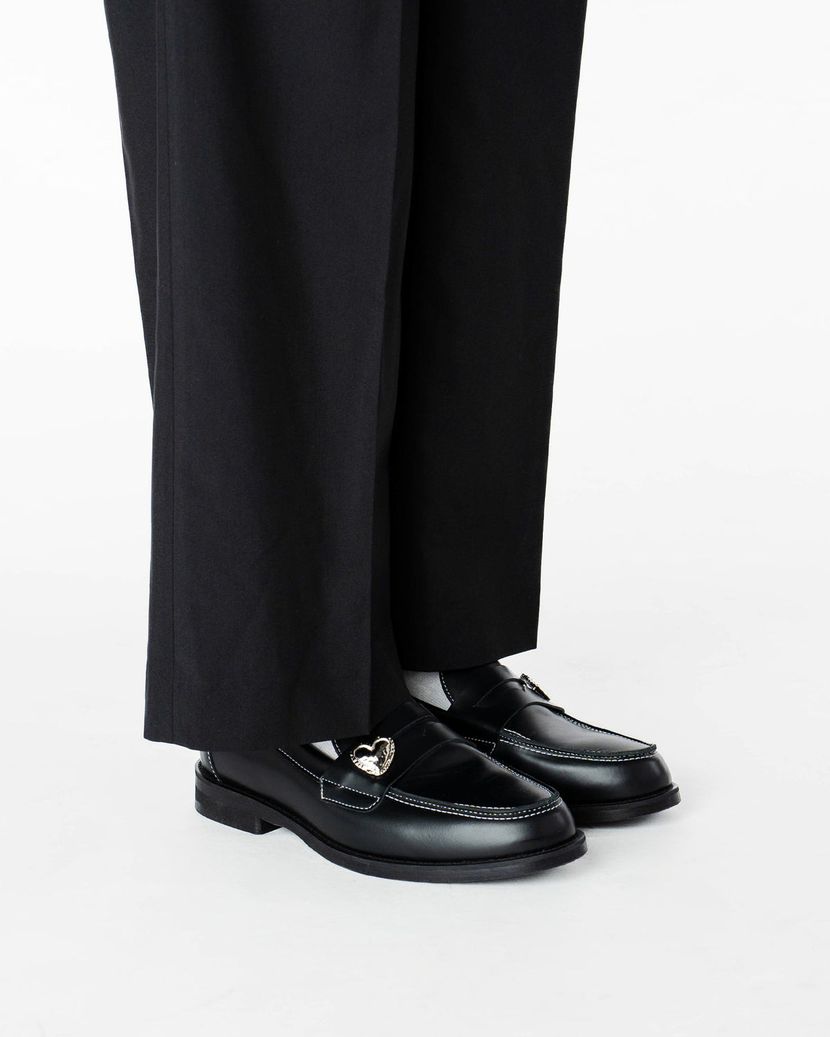 Heart Penny Pins on a pair of penny loafer wearing them in a side view