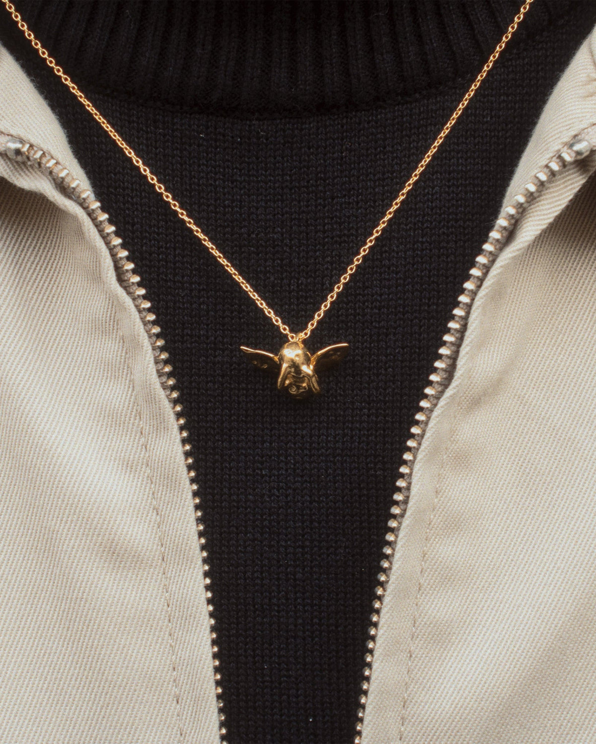 Cupid Necklace in gold worn with black turtleneck