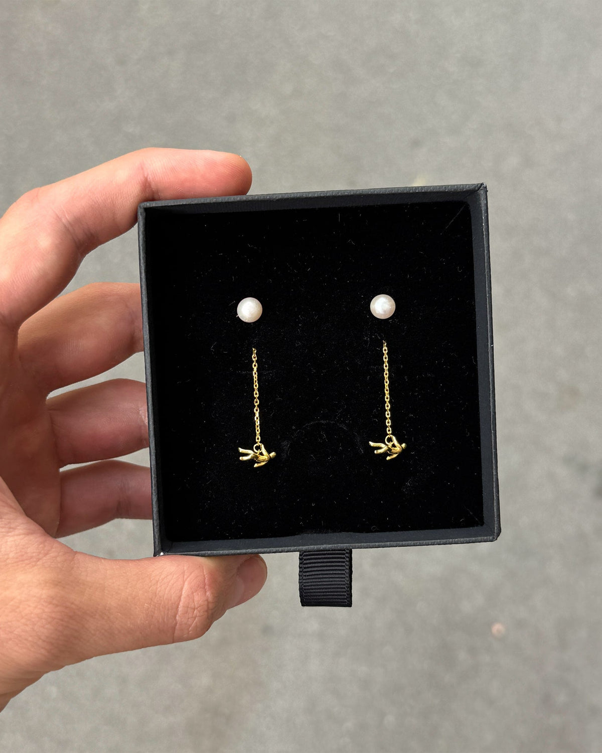 Icarus Earrings in gold inside packaging