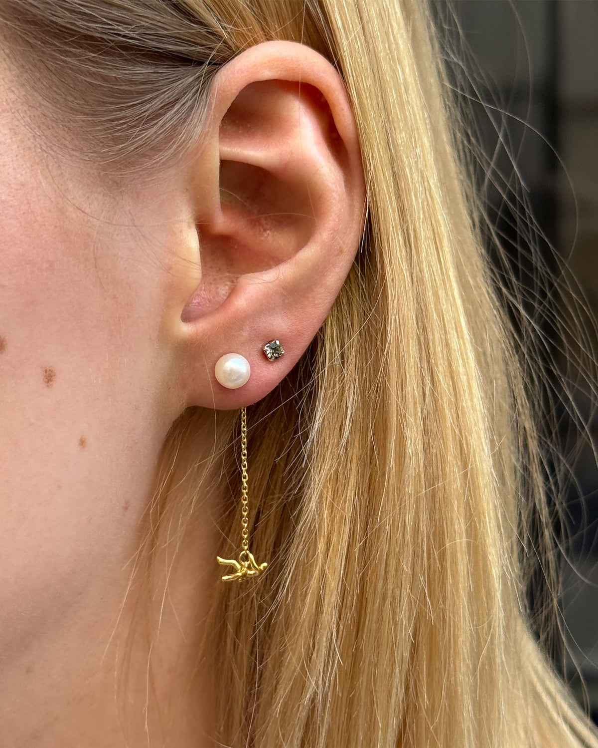 Icarus Earrings worn in gold