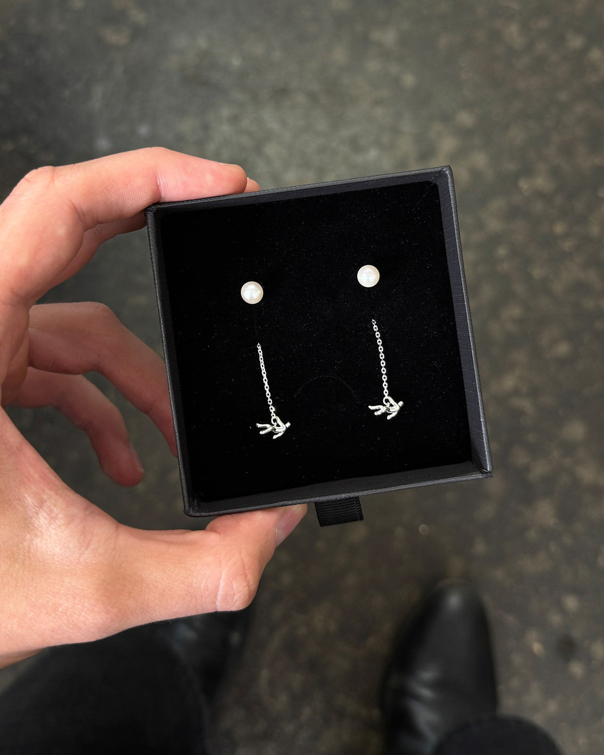 Icarus Earrings in silver inside packaging
