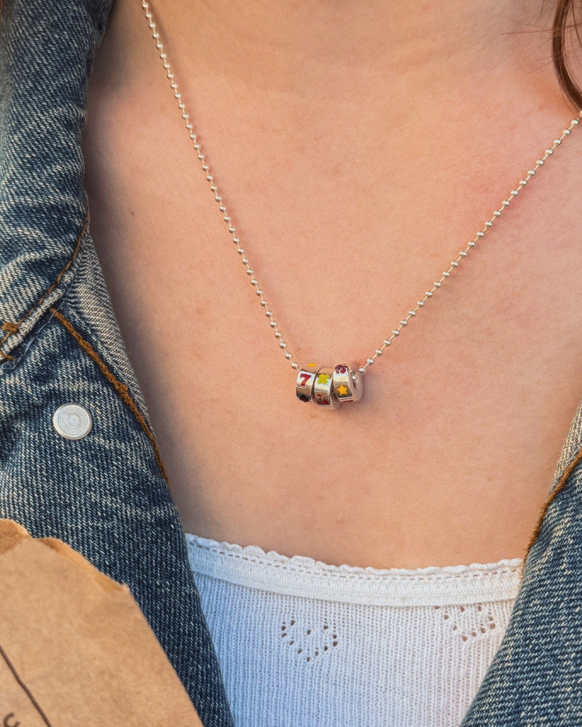 Lycka Necklace worn by a female