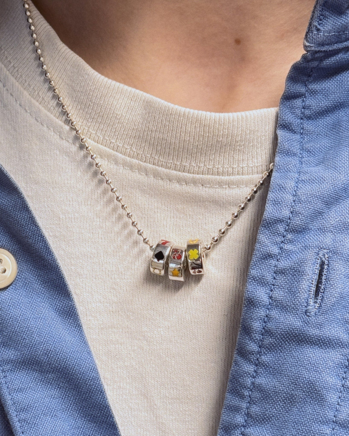 Lycka Necklace worn on tshirt with blue shirt