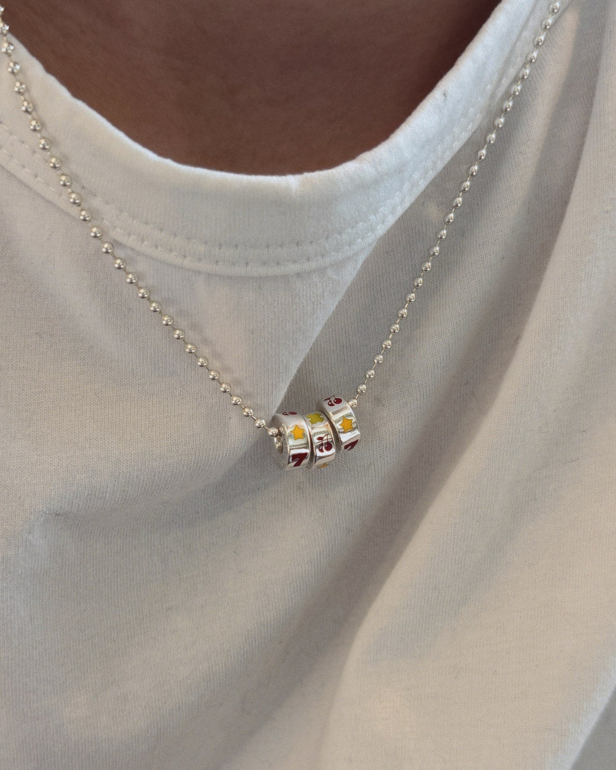 Lycka Necklace worn on white tshirt
