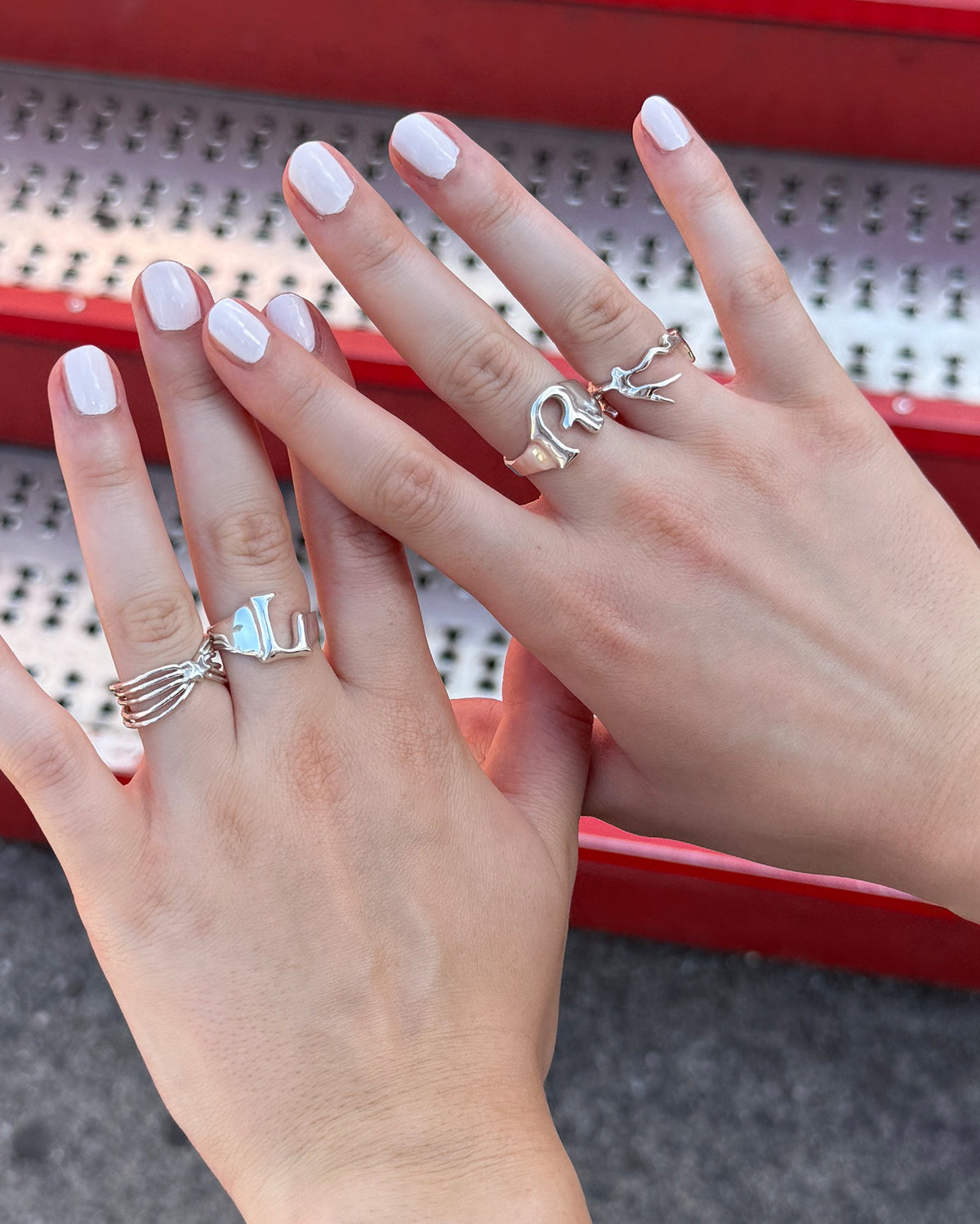 girl showing the rings on her hand including the Left/Right Rings in silver