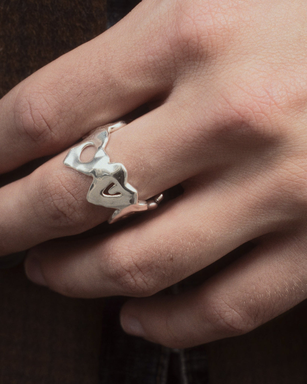 close up of love ya ring in silver on hand