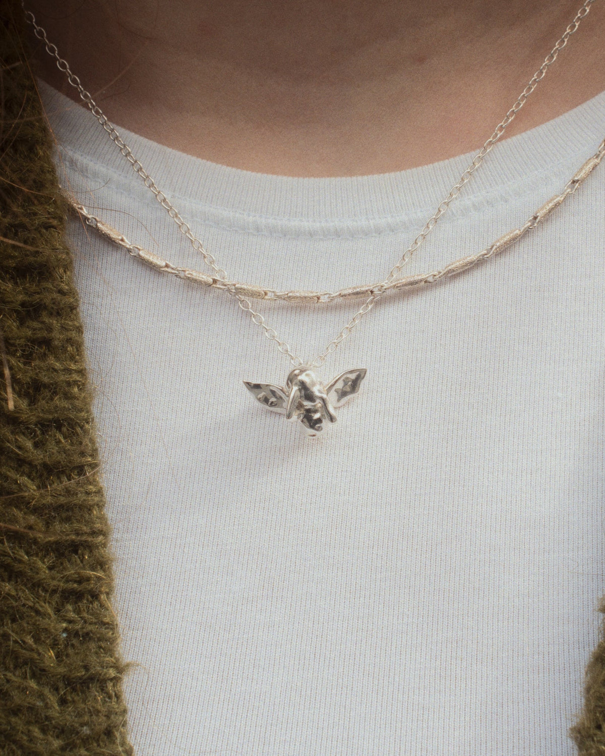 Pen Necklace worn on tshirt with Cupid Necklace