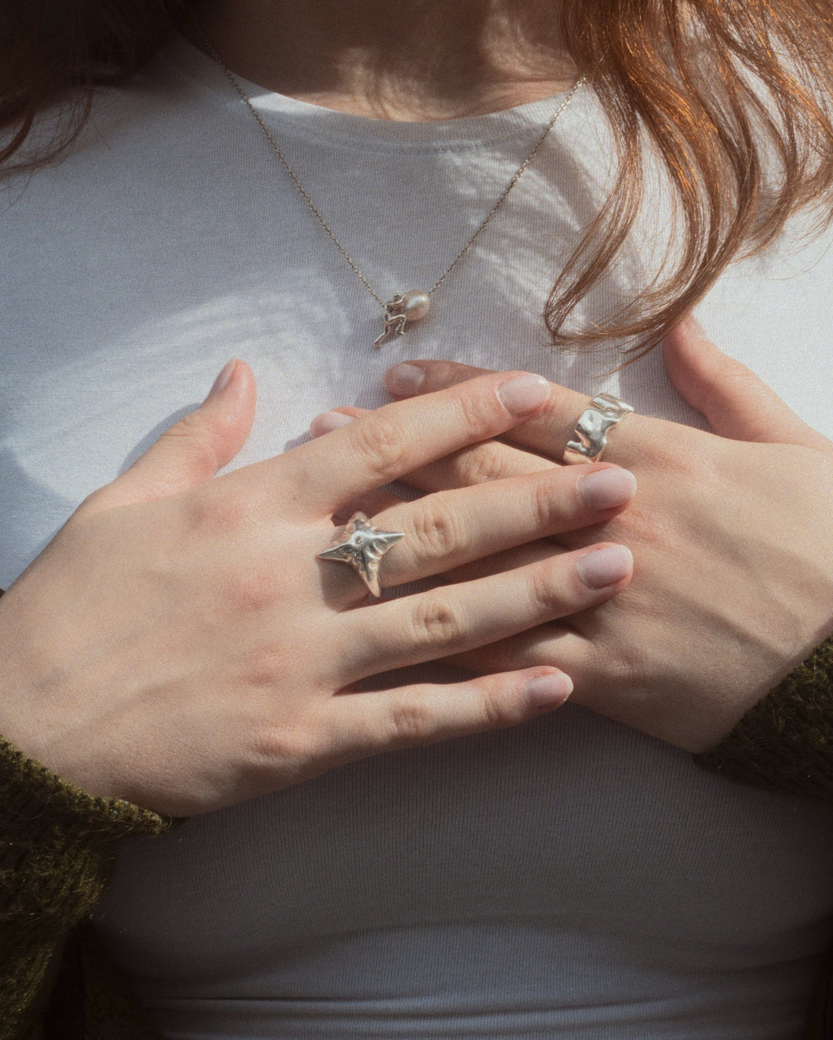 Sisyphus Necklace worn on female model with other jewelry