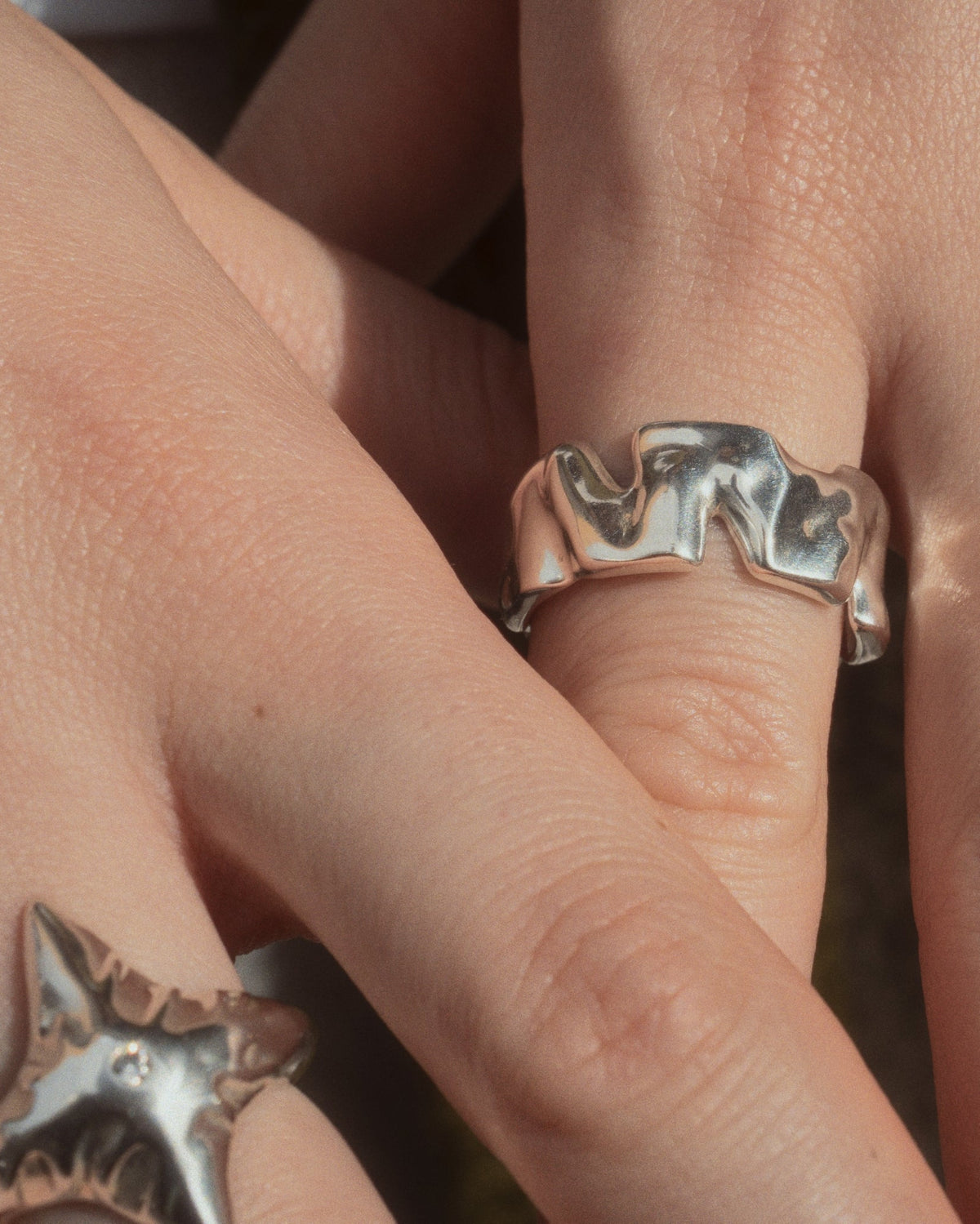 Human Ring in silver worn next to Star Ring