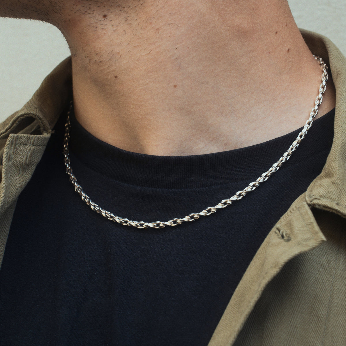 Hammered Necklace in silver worn by male in black tshirt