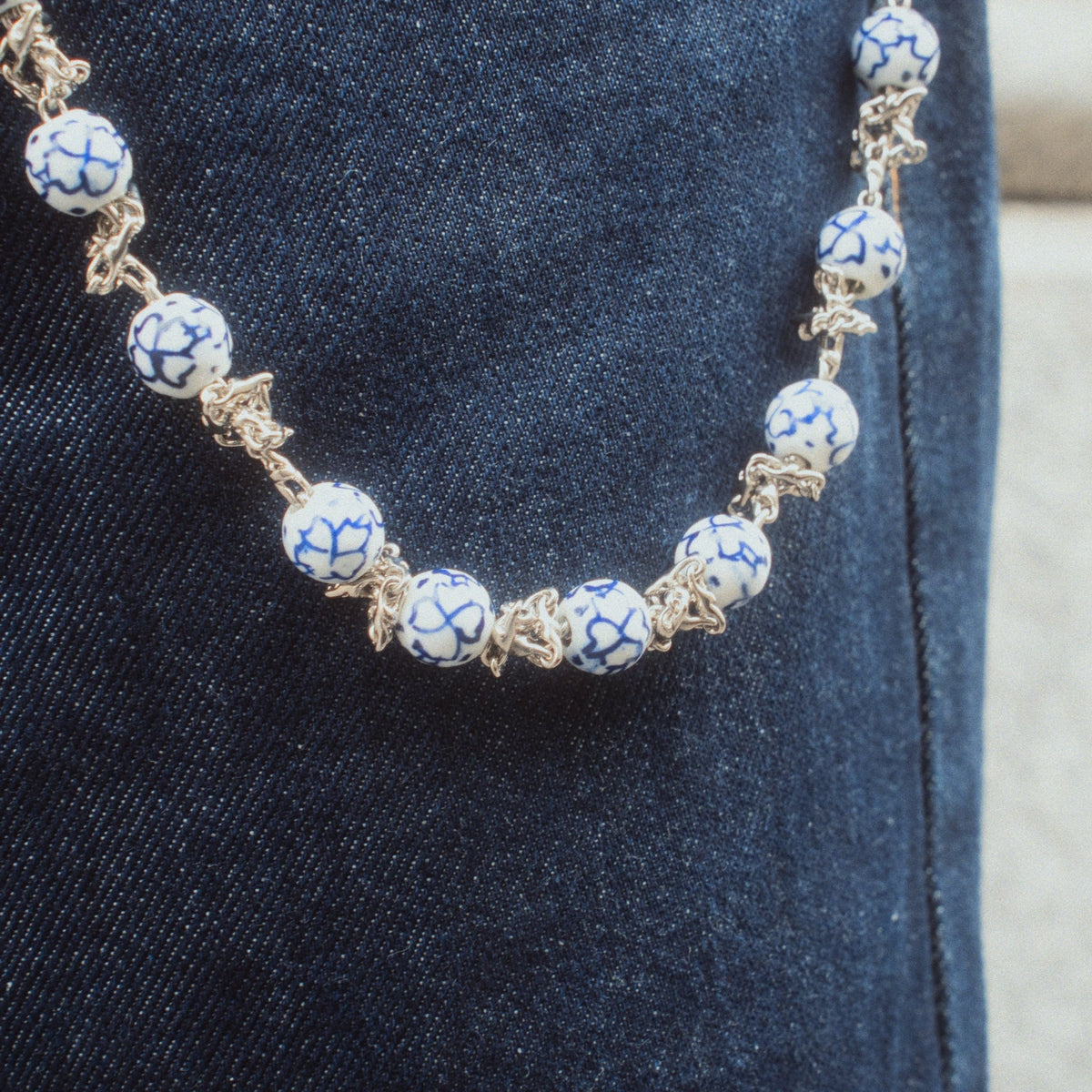 close up of ceramic wallet chain worn on jeans