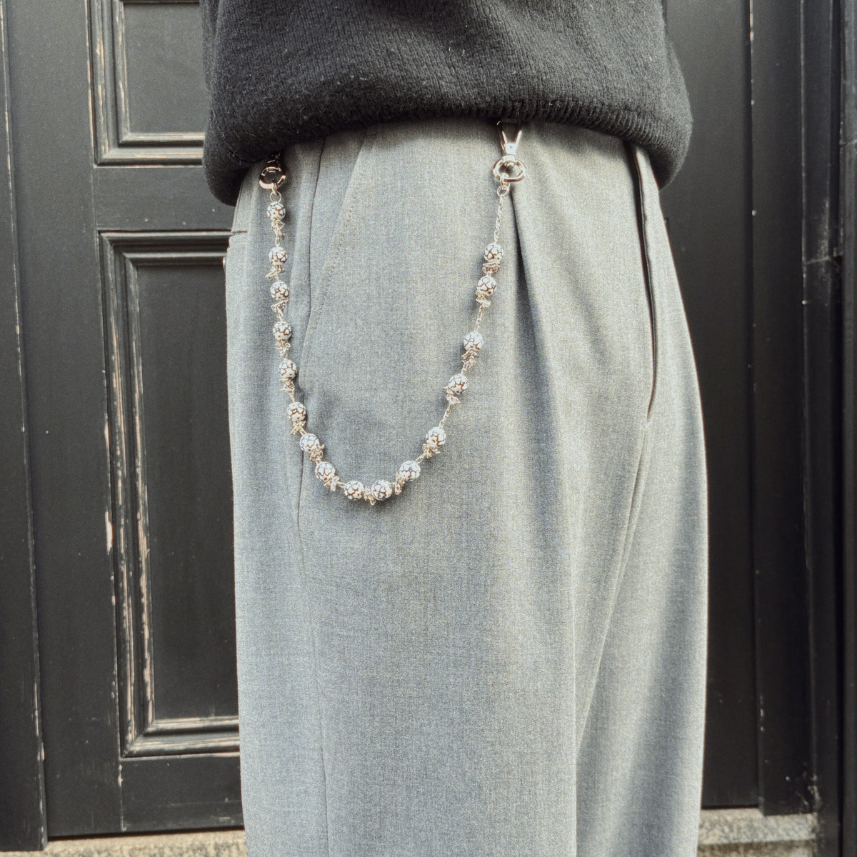 ceramic wallet chain worn on grey suit pants