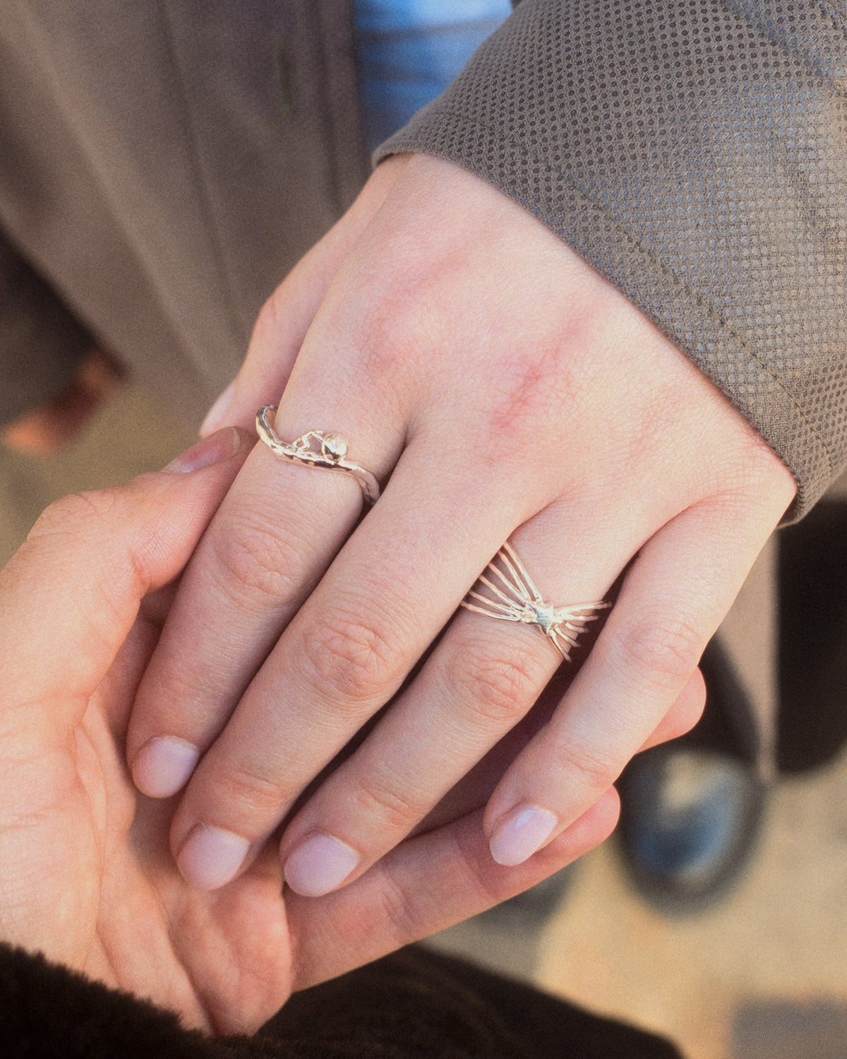 male holding female hand while wearing Sisyphus Ring