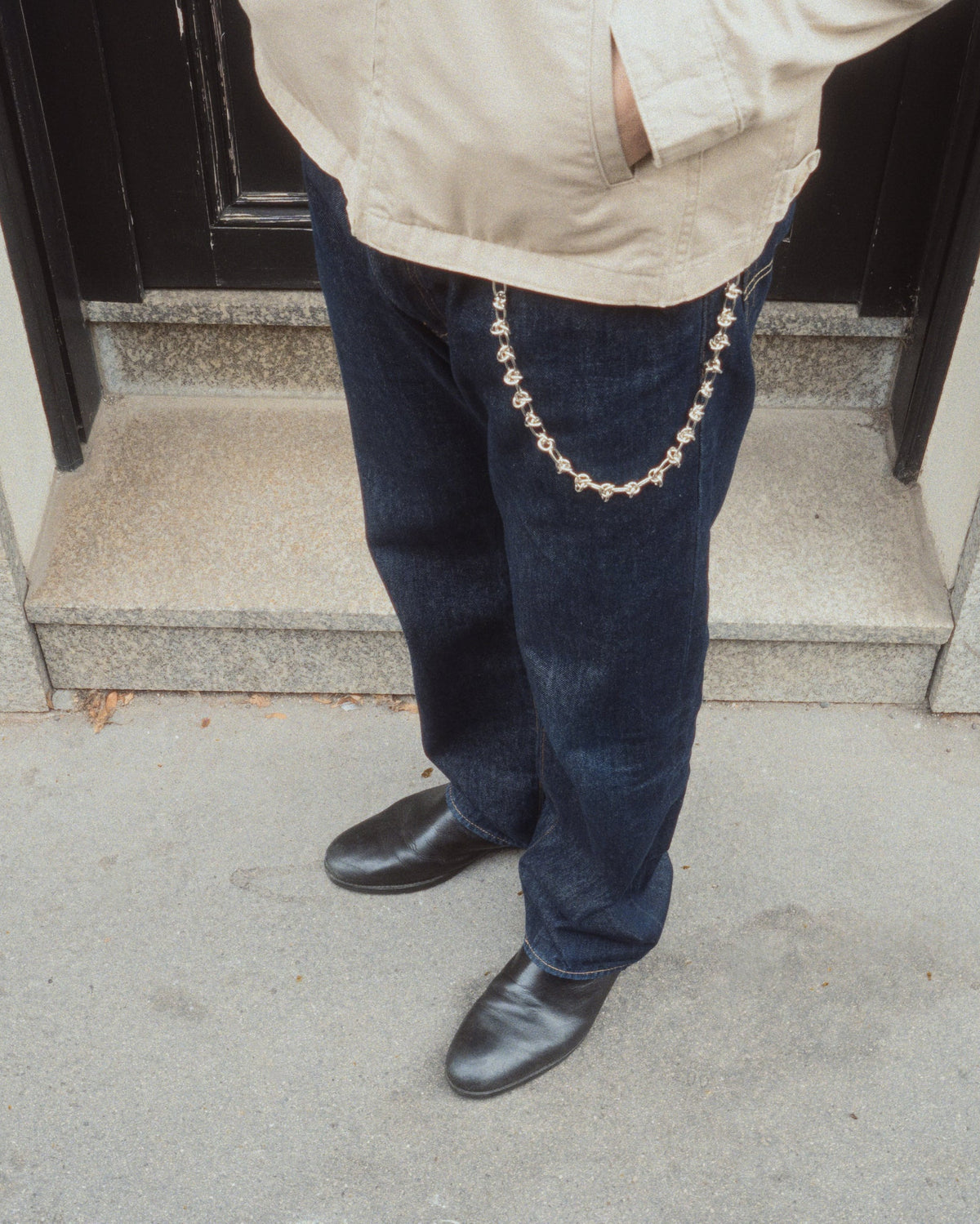 guy in jeans and boots wearing knot wallet chain
